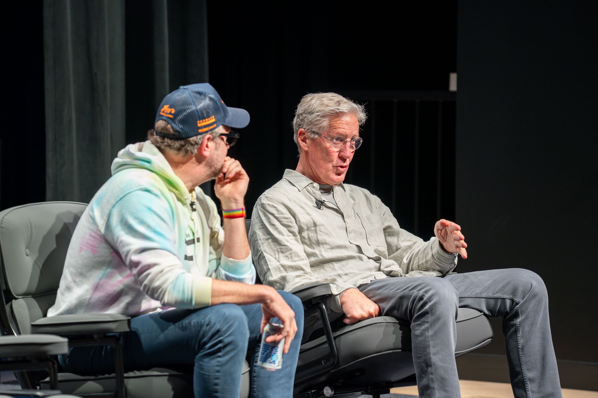 Close two-shot of Sudeikis and Carroll in deep conversation on stage